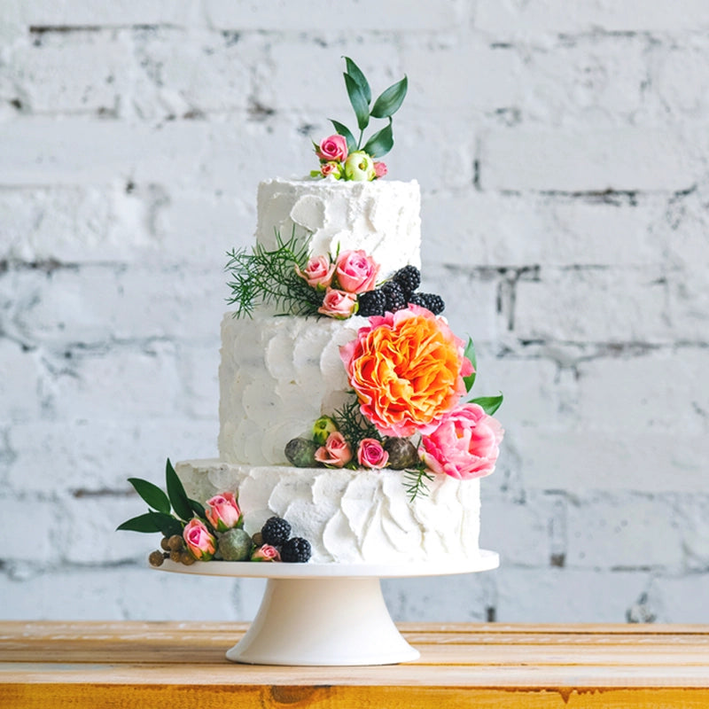 Three-Tier White Wedding Cake with Flowers in Qatar